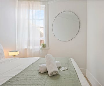 Cosy private double room with large mirror with complimentary toiletries and towels.