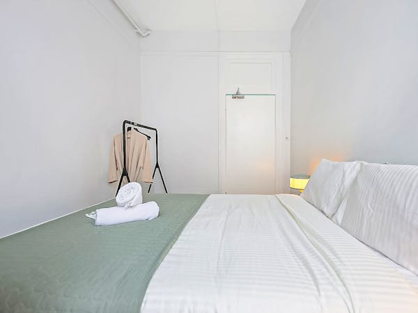 Cosy private double room with large mirror and clothes rail.