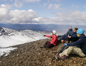 Guide pointing out to Kaimanawa ranges from Mt Tongariro