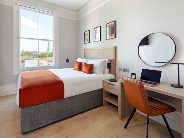modern bedroom with large double bed and shard view