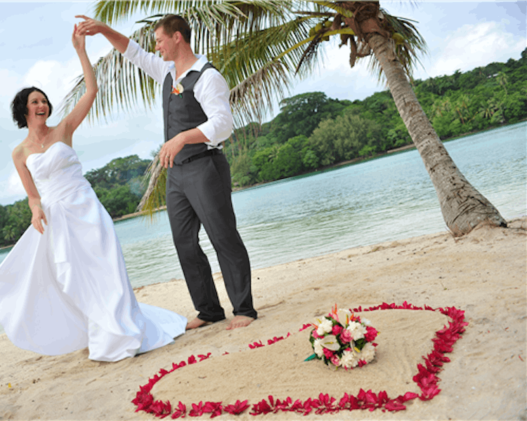 Ceremony on Coconut Beach with floral heart in the sand #erakorbeachweddings #weddingceremonyonthebeachsouthpacific #Vanuatu