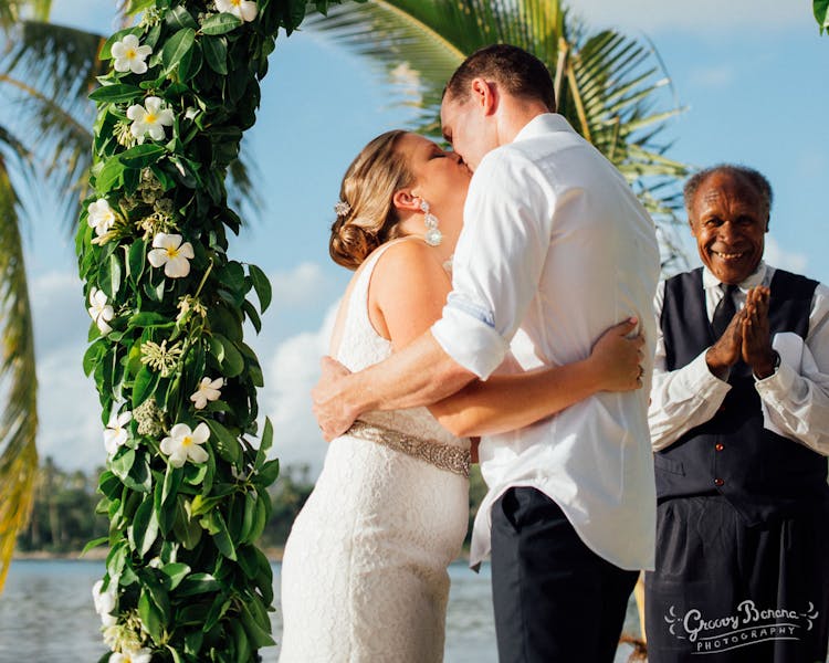 Coconut Beach with a beautiful Floral Arch #erakorweddings #weddingceremonyonthebeach #Vanuatutropicalbeachweddings