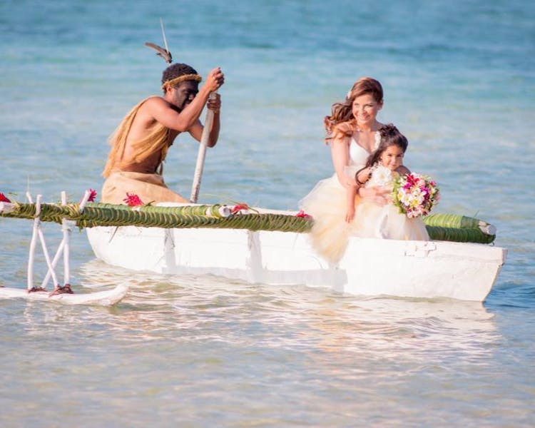 Bride & Flowergirl on the Outrigger Canoe #erakorbeachweddings #weddingceremonyonthebeachsouthpacific