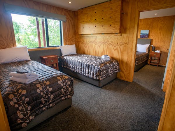 A timber room with two beds at Musterer's Accommodation, Fairlie.