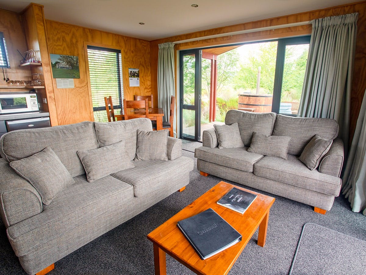 A modern-rustic living area with comfortable couches at Musterer's Accommodation, Fairlie.