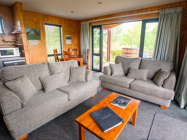 A modern-rustic living area with comfortable couches at Musterer's Accommodation, Fairlie.