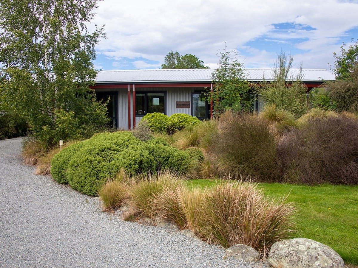 A rustic-modern cabin with green landscaping at Musterer's Accommodation, Fairlie.