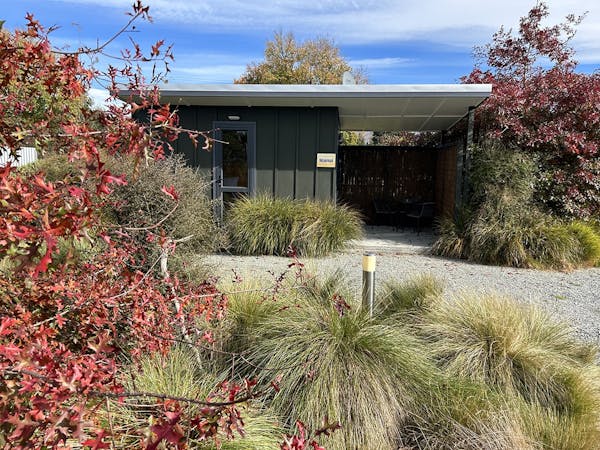 The Maimai studio cabin with native plants at Musterer's Accommodation, Fairlie.