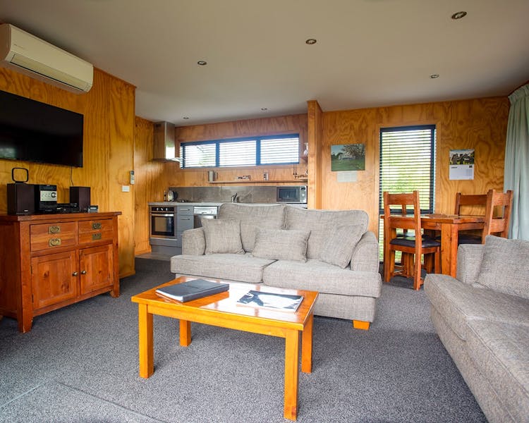 A modern-rustic living area with comfortable couches at Musterer's Accommodation, Fairlie.