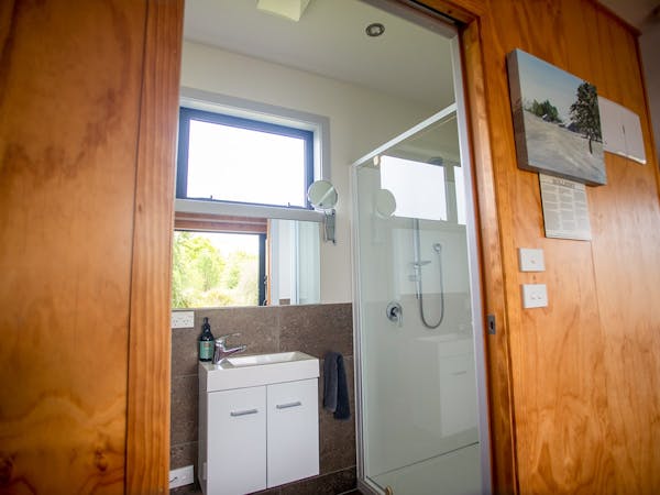 A bathroom with windows and natural light at Musterer's Accommodation, Fairlie.