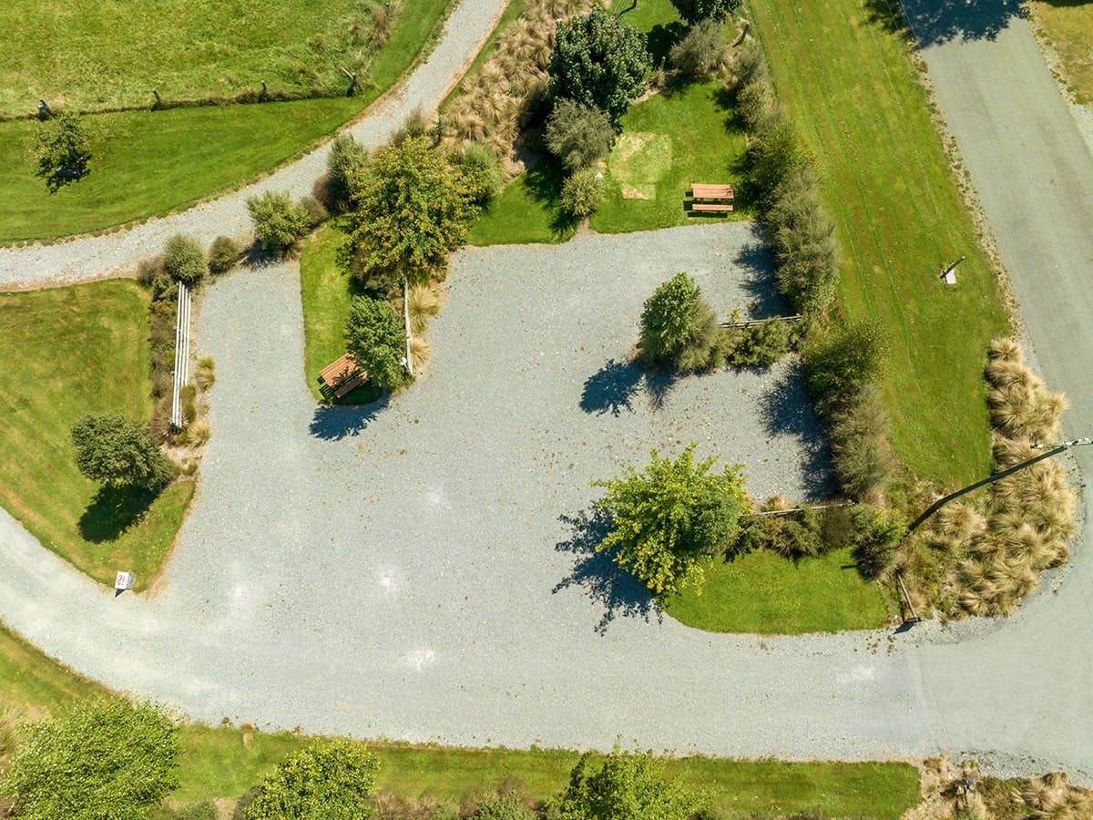 Large campervan parking area with trees and shrubs at Musterer's Accommodation, Fairlie.