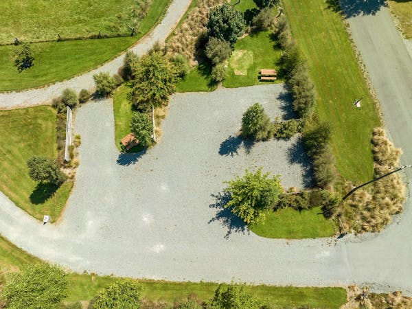 Large campervan parking area with trees and shrubs at Musterer's Accommodation, Fairlie.