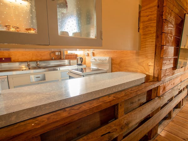 A rustic kitchen with dining bar at Musterer's Accommodation, Fairlie.