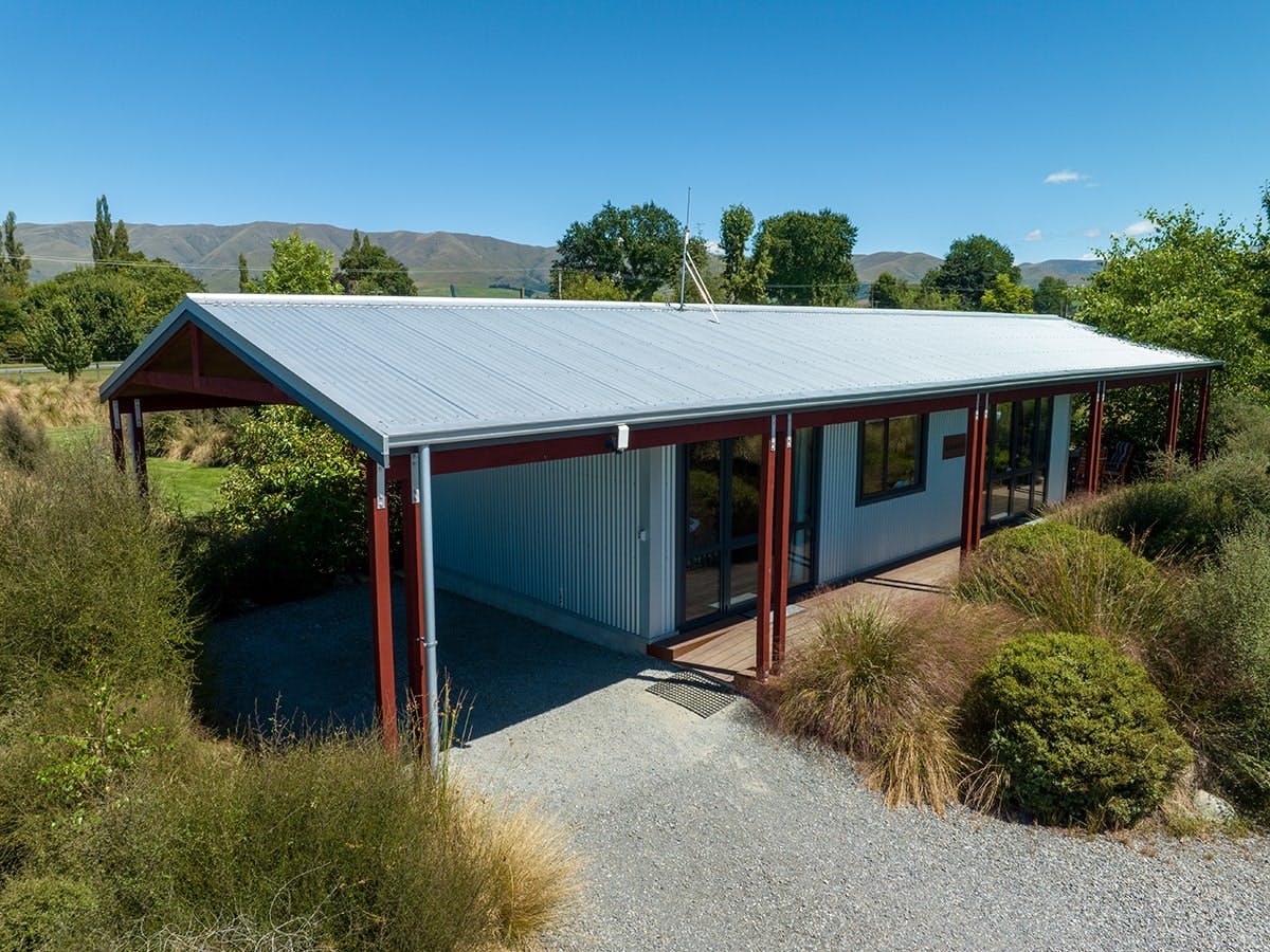 A modern-rustic cabin with native trees and plants at Musterer's Accommodation, Fairlie.