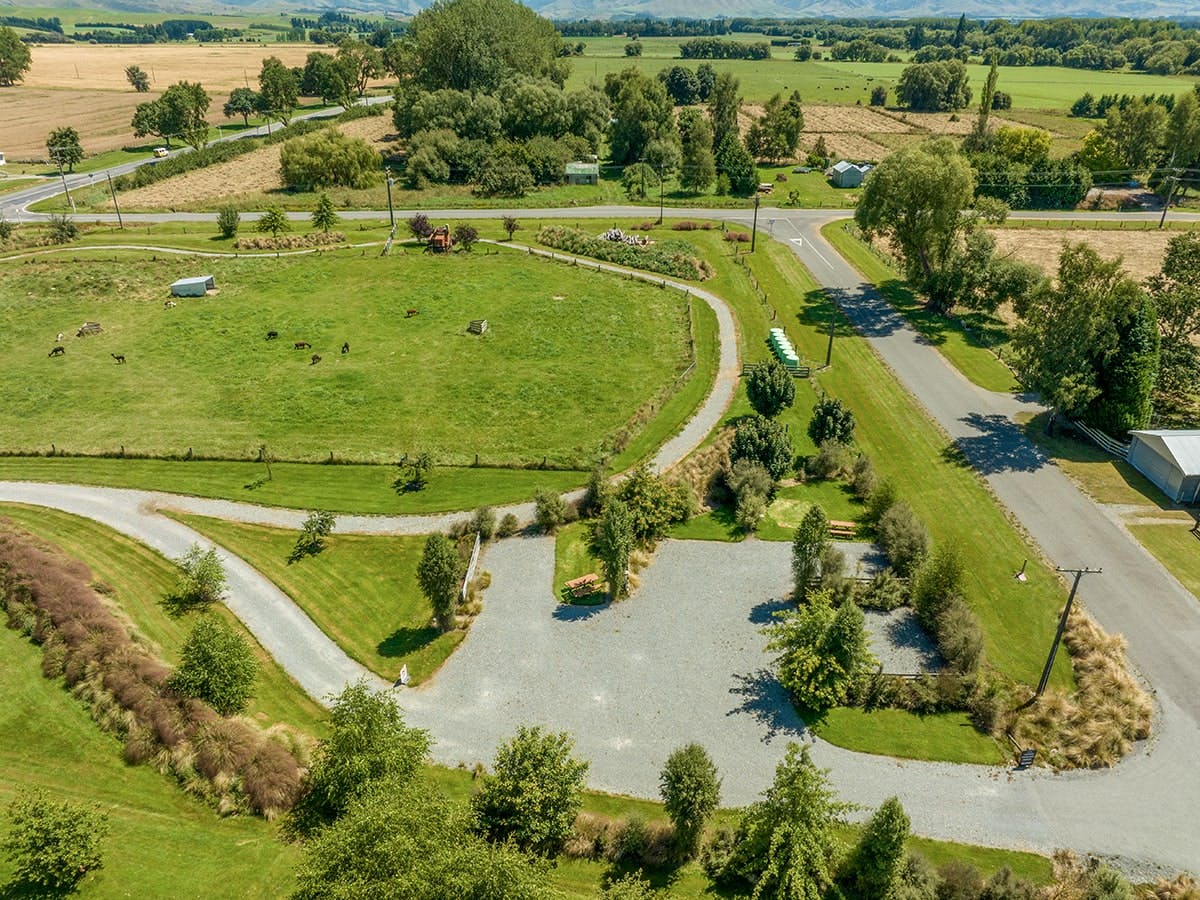 A large parking area with green landscaping at Musterer's Accommodation, Fairlie.