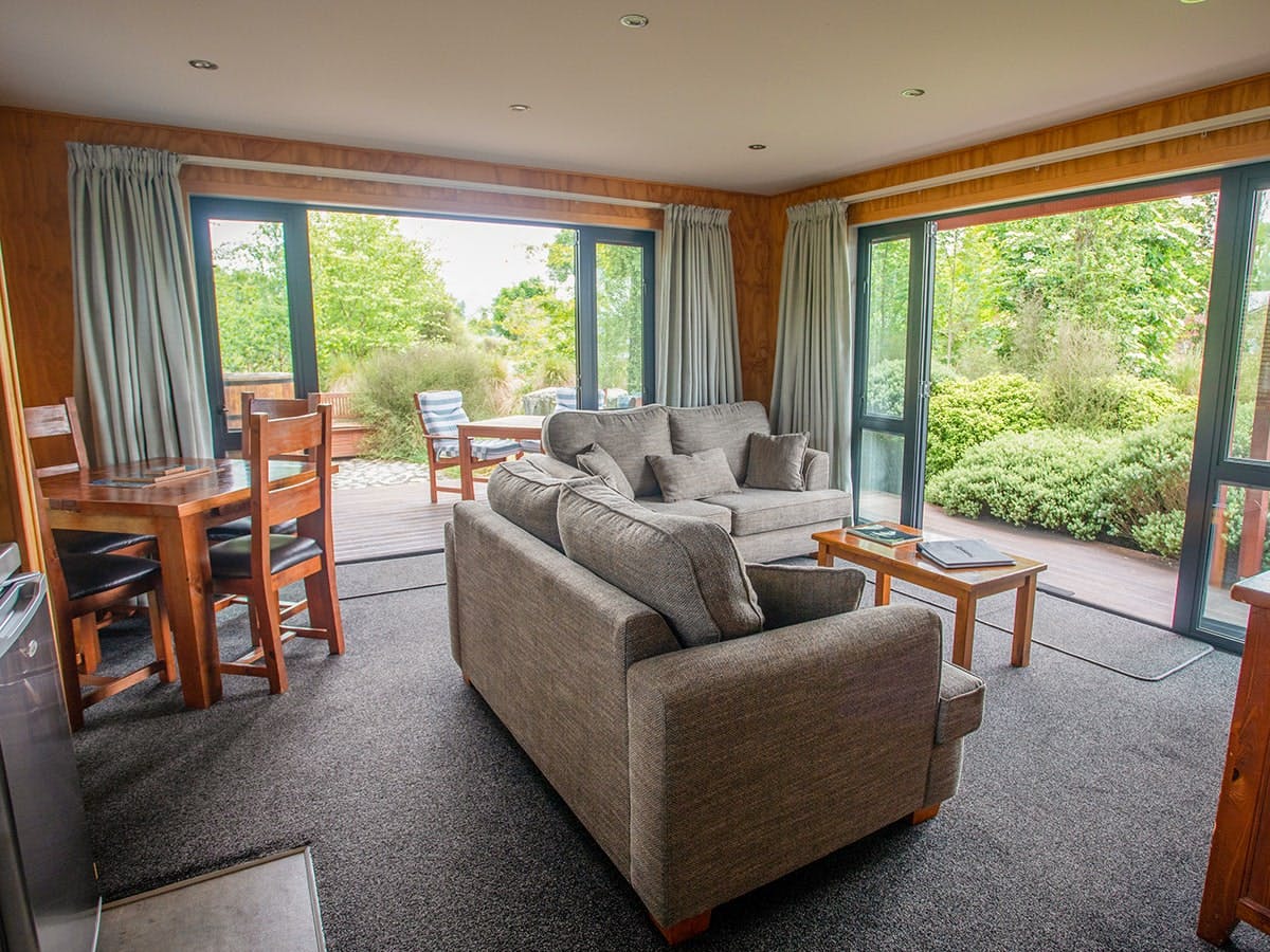 A modern-rustic living area with comfortable couches at Musterer's Accommodation, Fairlie.