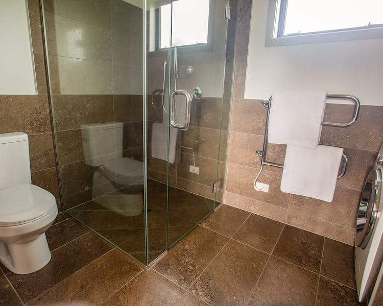 A rustic-modern bathroom with large shower at Musterer's Accommodation, Fairlie.