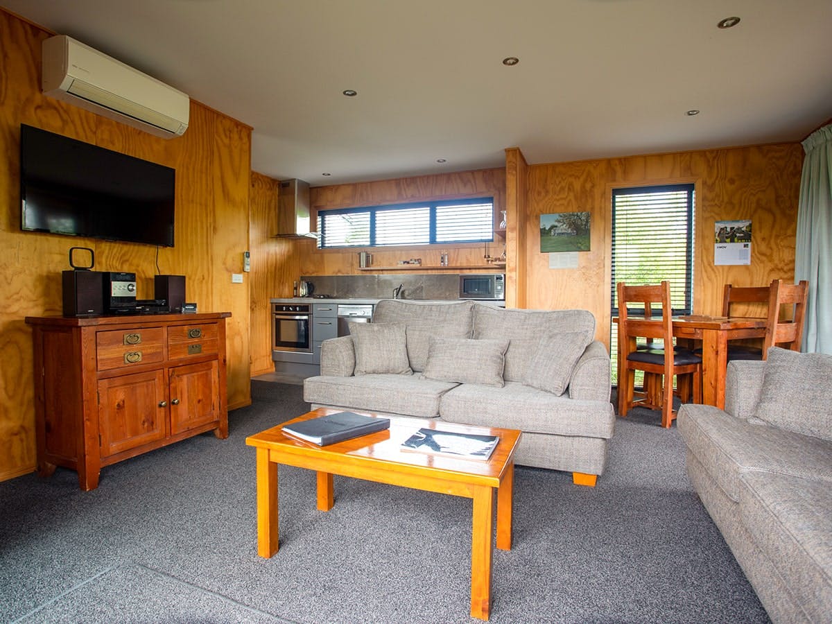 A modern-rustic living area with comfortable couches at Musterer's Accommodation, Fairlie.