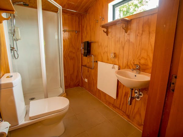 A rustic-modern bathroom with wall heater at Musterer's Accommodation, Fairlie.