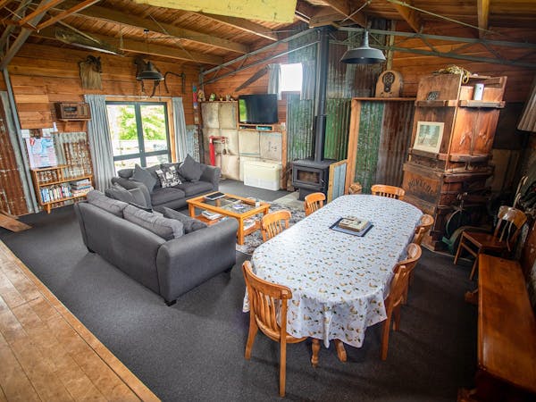 A large rustic living area in an old woolshed at Musterer's Accommodation, Fairlie.