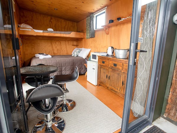 A rustic studio cabin with kitchenette at Musterer's Accommodation, Fairlie.