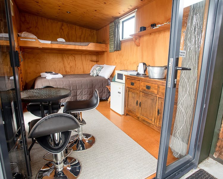A rustic studio cabin with kitchenette at Musterer's Accommodation, Fairlie.
