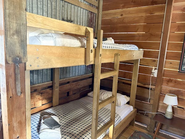 A rustic bunkroom with sturdy timber bunks at Musterer's Accommodation, Fairlie.