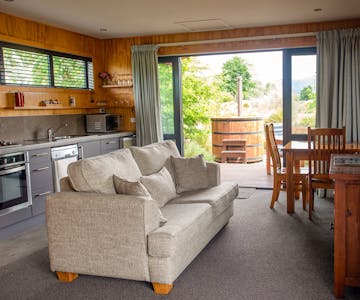 A modern-rustic living area and outdoor hot tub at Musterer's Accommodation, Fairlie.