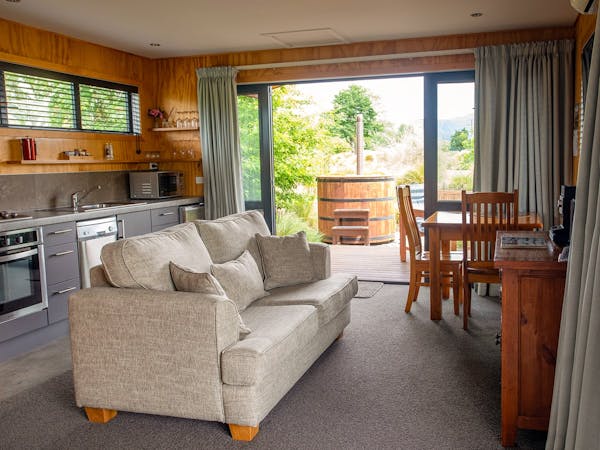 A modern-rustic living area and outdoor hot tub at Musterer's Accommodation, Fairlie.