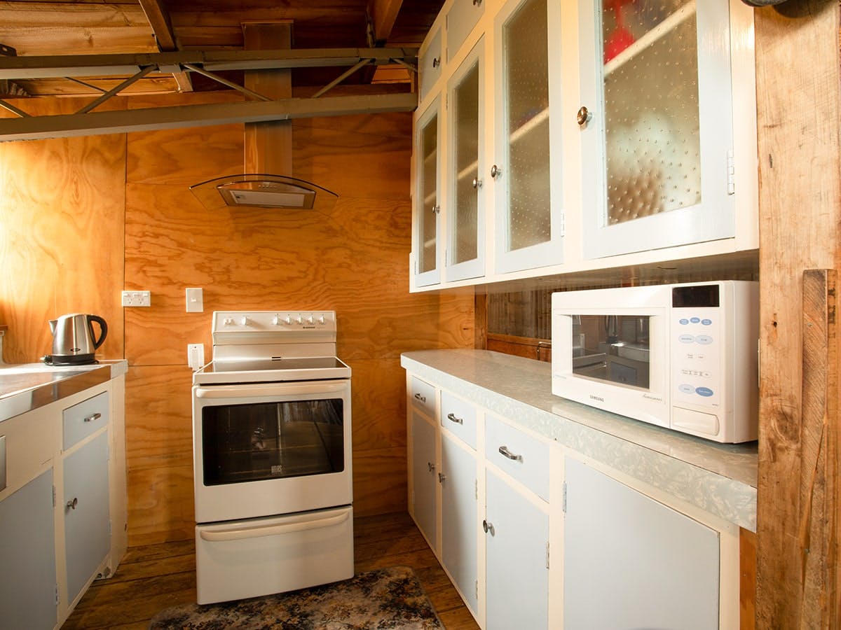 A rustic kitchen with full oven at Musterer's Accommodation, Fairlie.