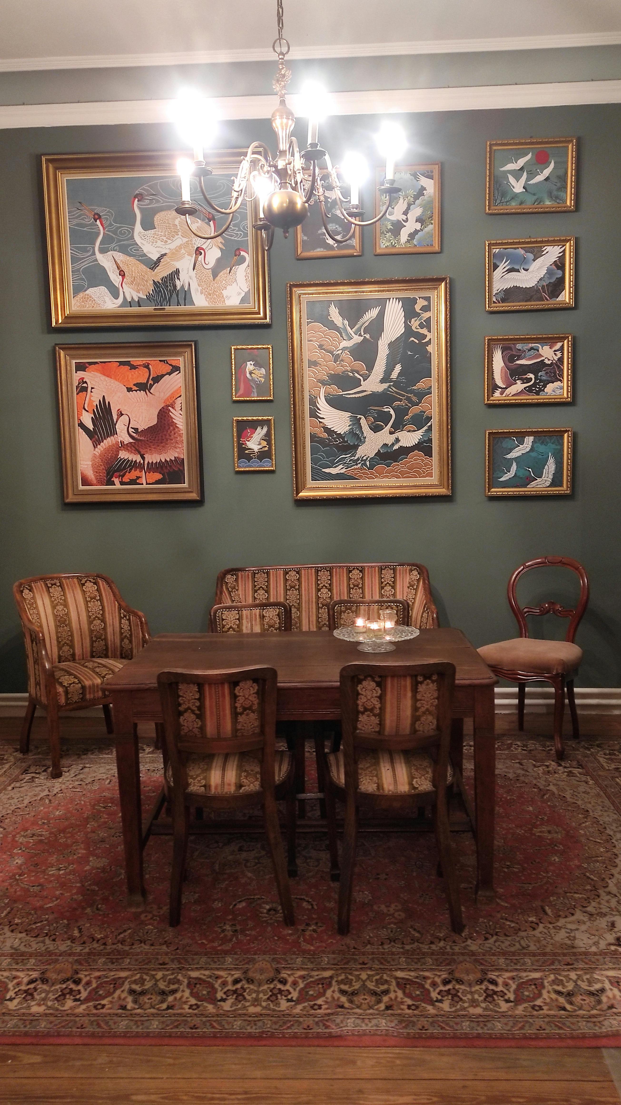 Authentic salon at La Maison Vienvenue with crane bird paintings, ideal for board games after a day of cycling or hiking.