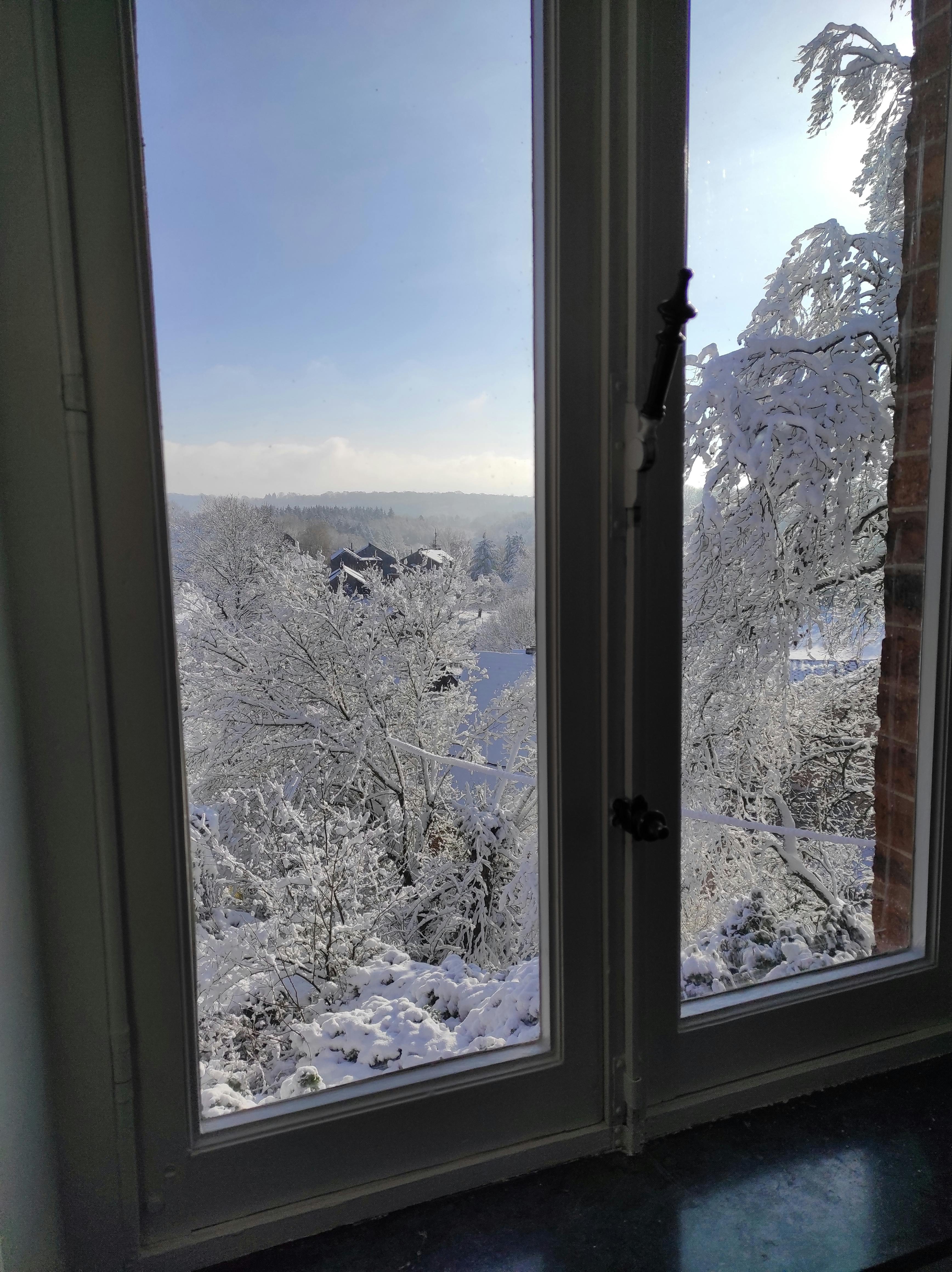 iew of the snowy landscape of the Ourthe Valley from the window of a room at La Maison Vienvenue, a cycling accommodation.
