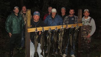 alt="Guest showing off a large fish caught at Best Bear Lodge & Campground in Irons Michigan"