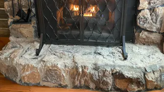 Lincoln Hills Cabin Fireplace at Best Bear Lodge & Campground. Irons, Michigan