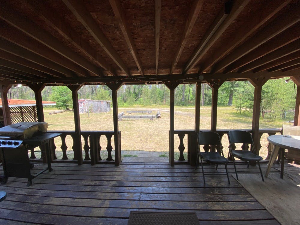 Lincoln Hills Cabin Covered Deck at Best Bear Lodge & Campground. Irons, Michigan