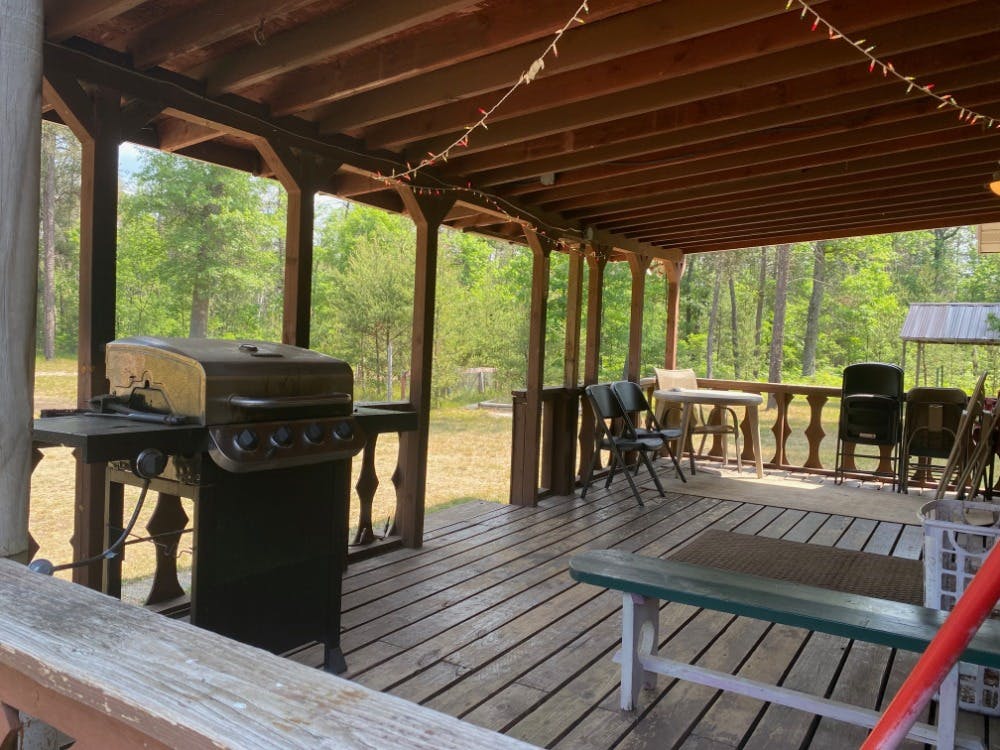 Lincoln Hills Cabin Covered Deck at Best Bear Lodge & Campground. Irons, Michigan