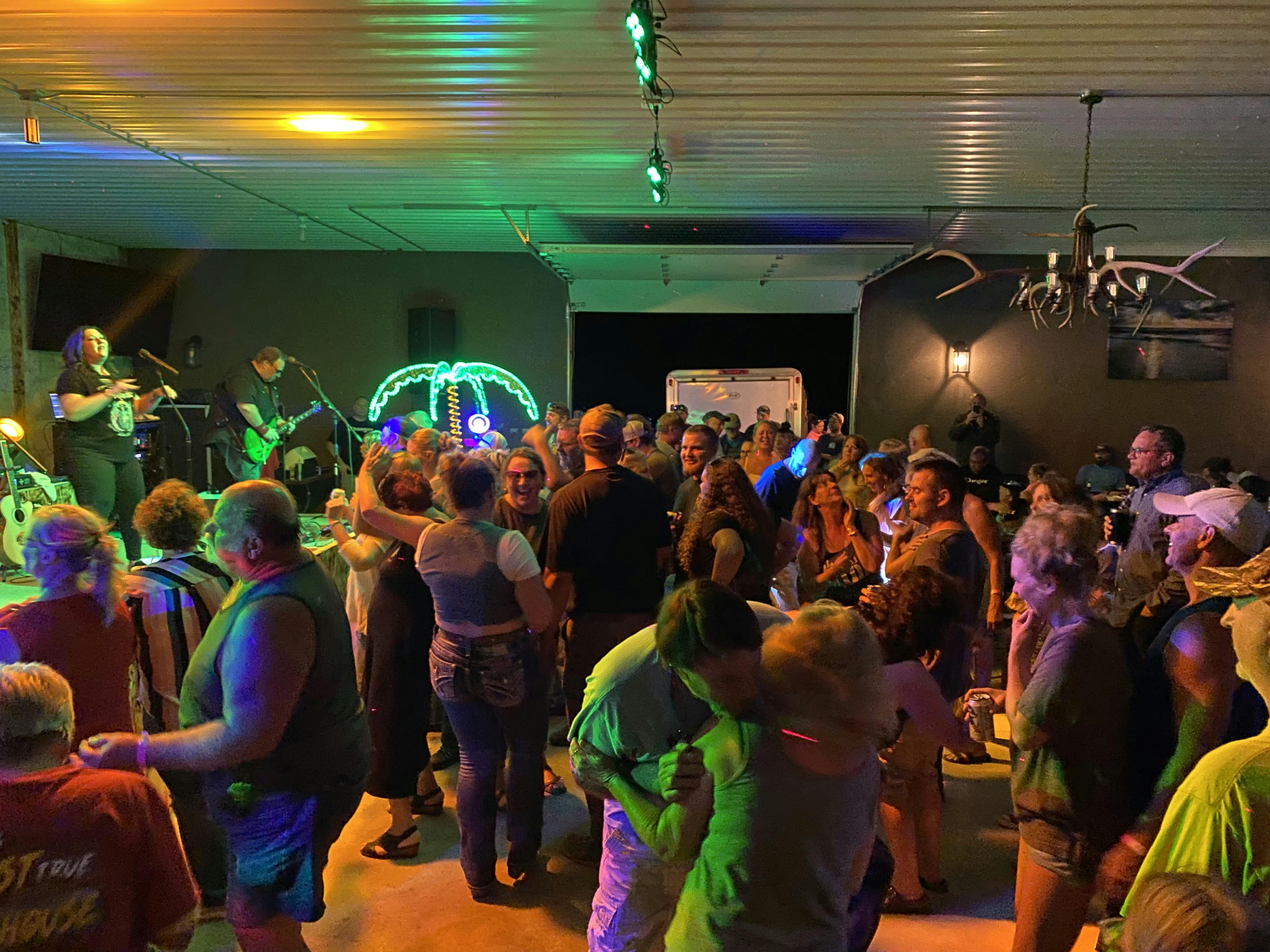 Onager Band performing live while people are dancing in the Rhinestone Event Center at Best Bear Lodge & Campground.