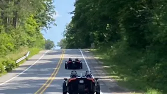 Group Polaris Slingshot rental adventure on the paved backroads of Irons, Michigan.