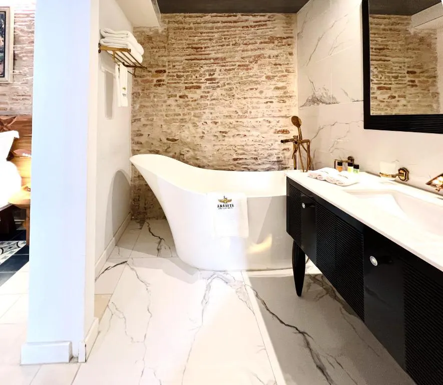 Luxury bathroom with freestanding bathtub and natural stone wall