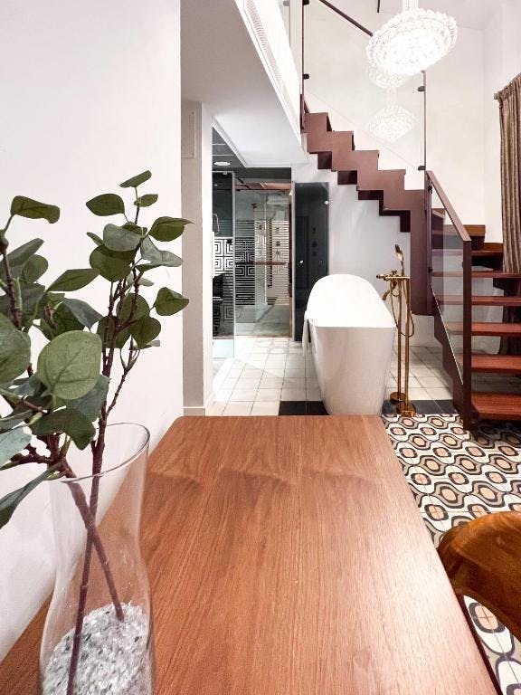 Boutique entrance hall with staircase and wood accents
