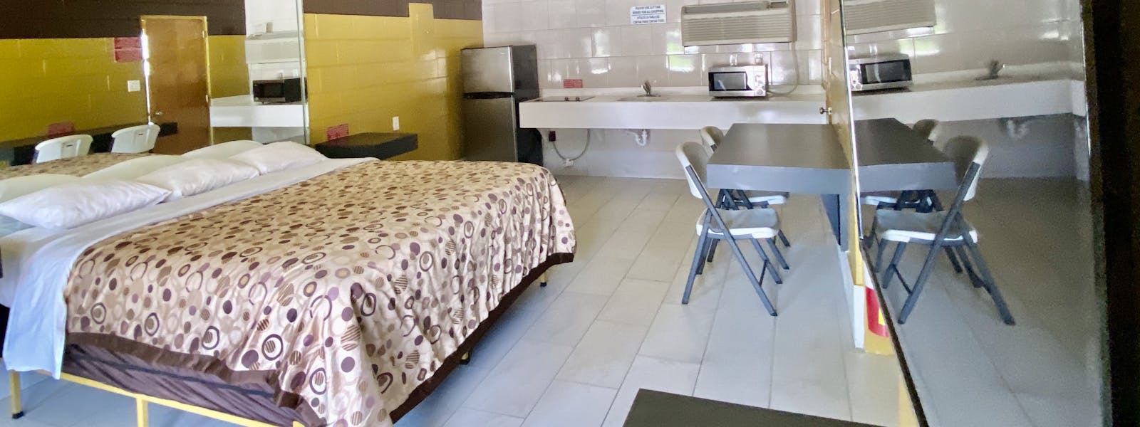 king, king bedroom, kitchenette, refrigerator, microwave, stove top, cooktop, table, chair