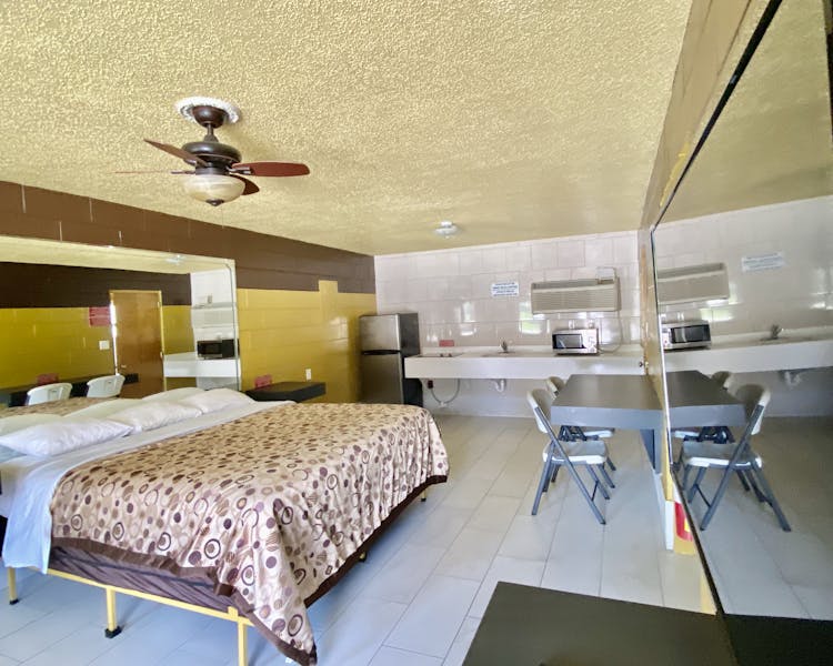 king, king bedroom, kitchenette, refrigerator, microwave, stove top, cooktop, table, chair