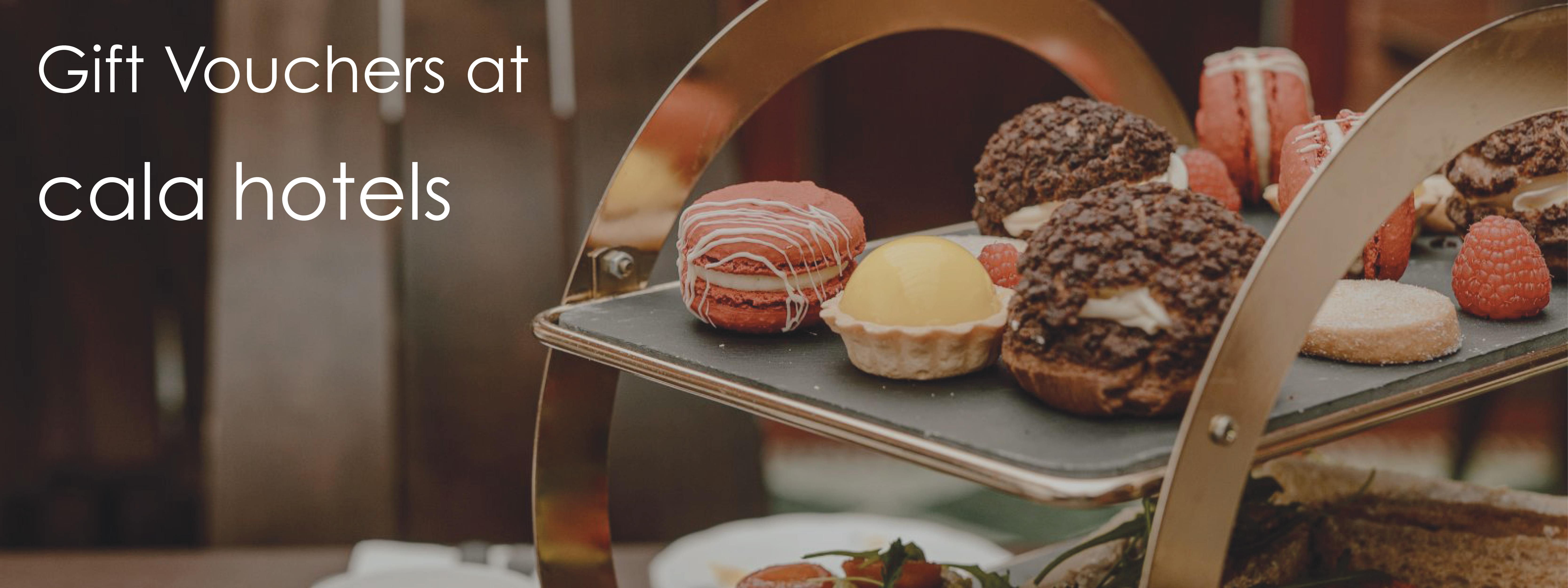 A table displaying an afternoon tea tray of pastries highllighting gift vouchers available