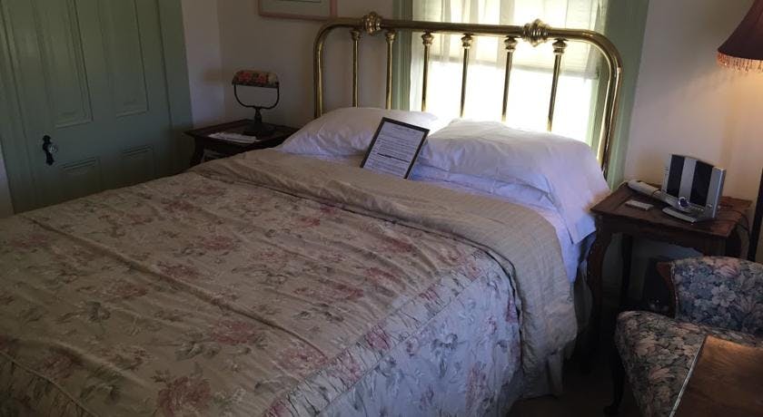 Queen bed with brass headboard in Tioga Room