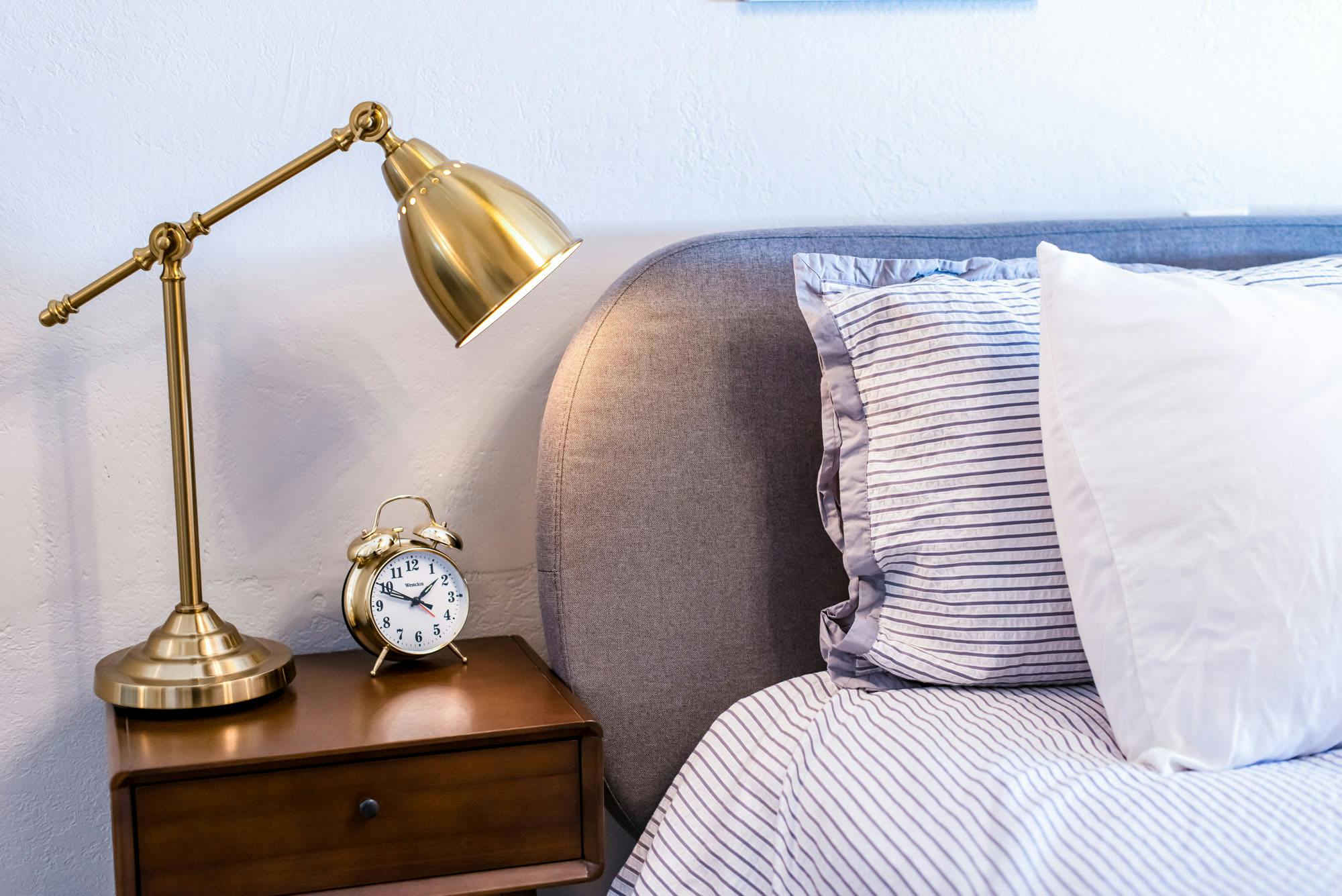 Luxury hotel room king bed and nightstand Beulah Michigan