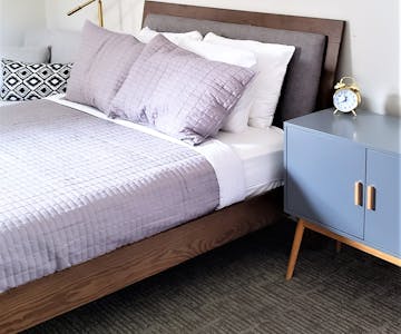 Luxury hotel room bed and nightstand Beulah Michigan