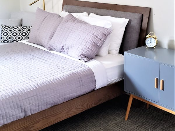 Luxury hotel room bed and nightstand Beulah Michigan