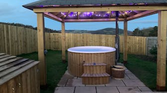 Fairy lights night time wood fired hot tub