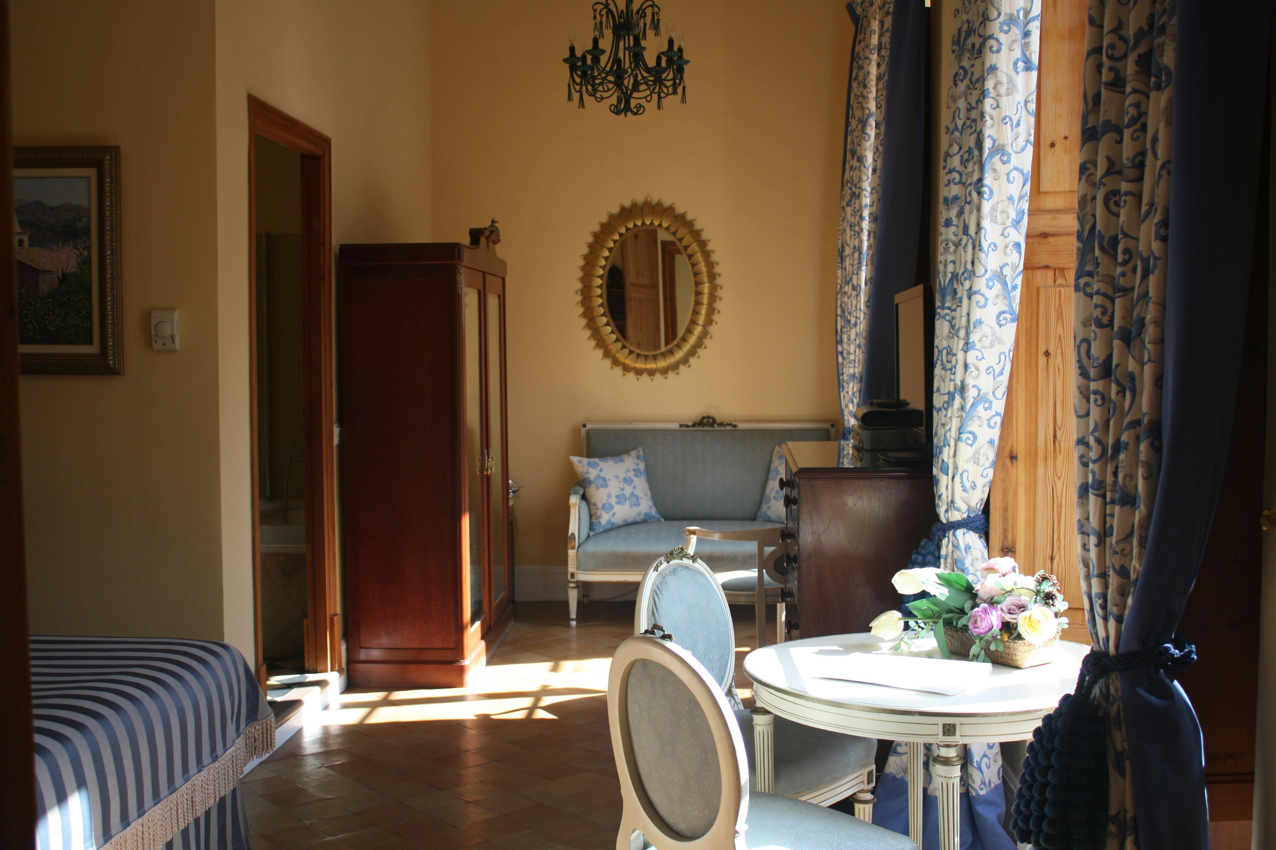 The sunlight streaming through the windows of the Sol Junior Suite