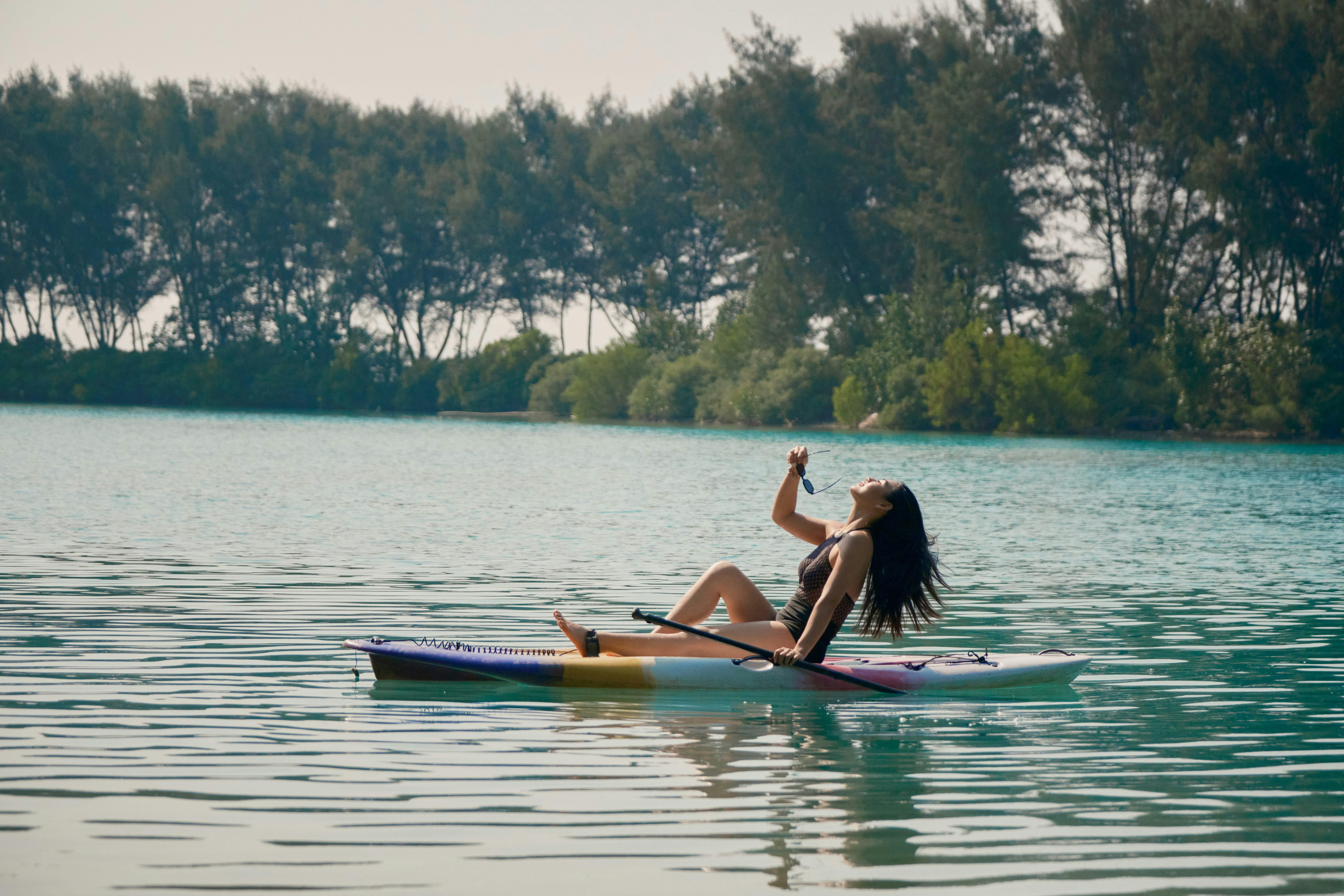 Girl paddle boarding with Batumera in Pulau Payung Lagoon in Thousand Islands
